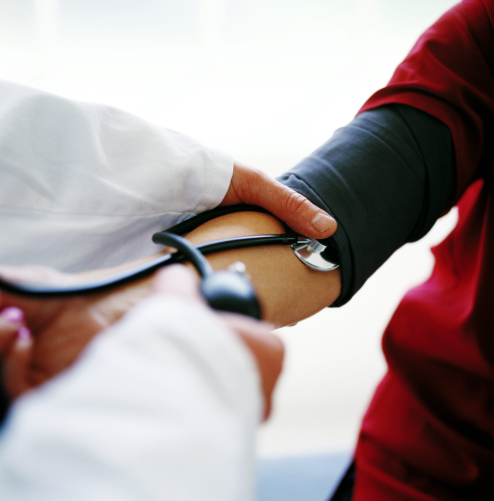 Close up of doctor taking patient blood pressure